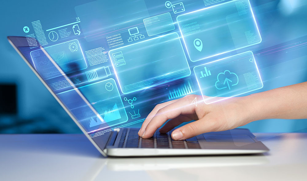 a hand downloading data from a laptop