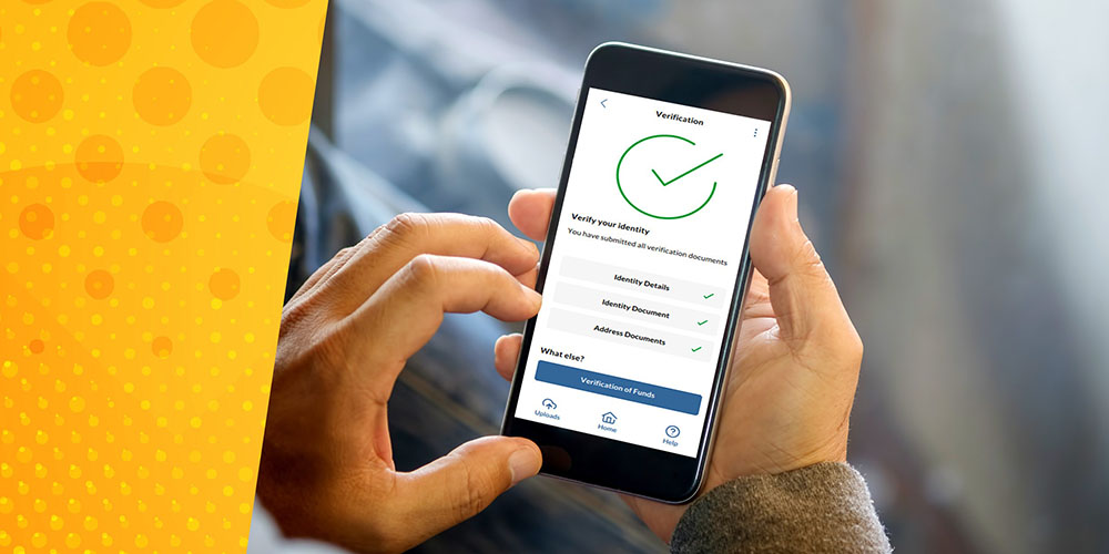 Hand holding mobile phone with confirm ID verification on screen